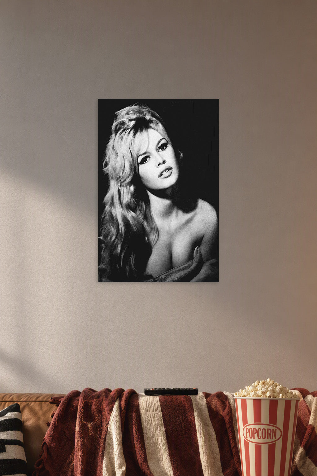 Brigitte Bardot in a cozy movie room above a brown sofa with popcorn.