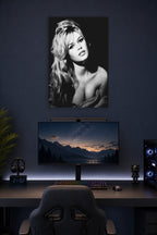 Brigitte Bardot in a gaming desk setup above a monitor.