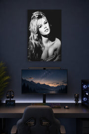 Brigitte Bardot in a gaming desk setup above a monitor.