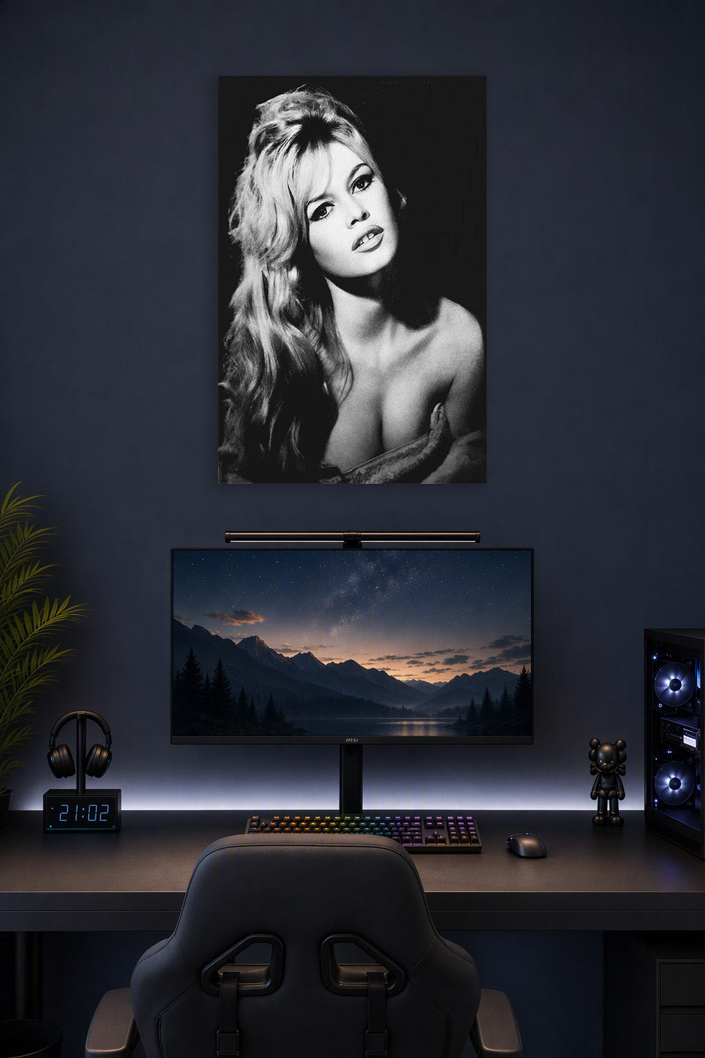 Brigitte Bardot in a gaming desk setup above a monitor.