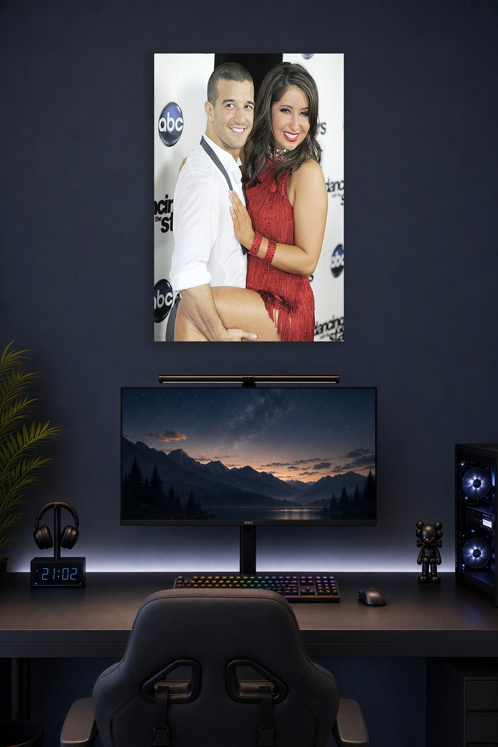 Bristol Palin and Mark Ballas in a gaming desk setup above a monitor.