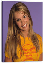 Britney Spears canvas wall art print featuring her smiling portrait in a yellow baseball graphic T-shirt on purple.