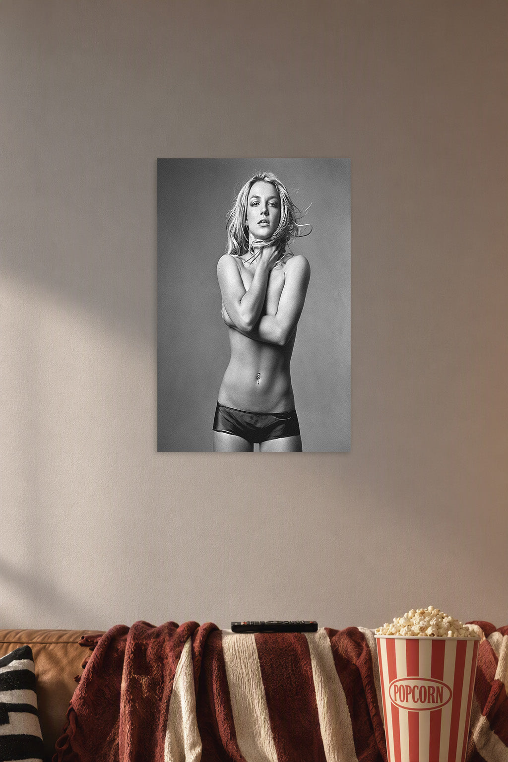 Britney Spears in a cozy movie room above a brown sofa with popcorn.