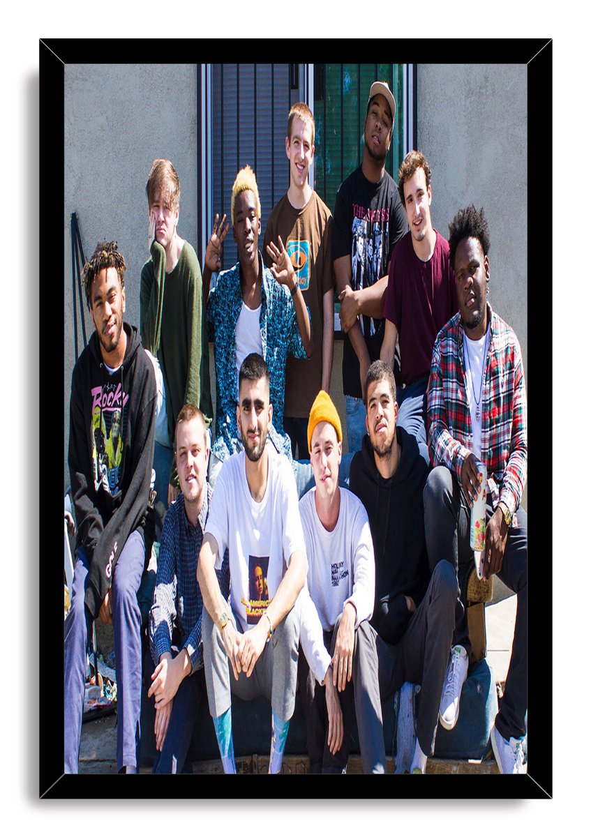 Brockhampton framed wall art print featuring eleven casually dressed members posed outdoors in a sleek black frame.