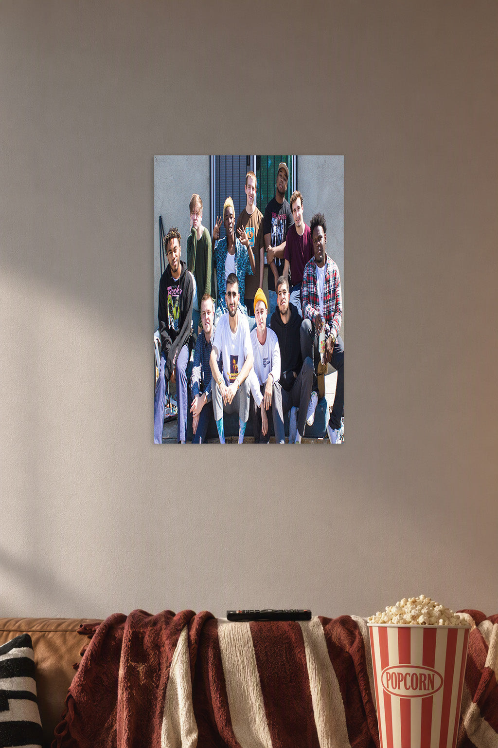 Brockhampton Music Collective in a cozy movie room above a brown sofa with popcorn.