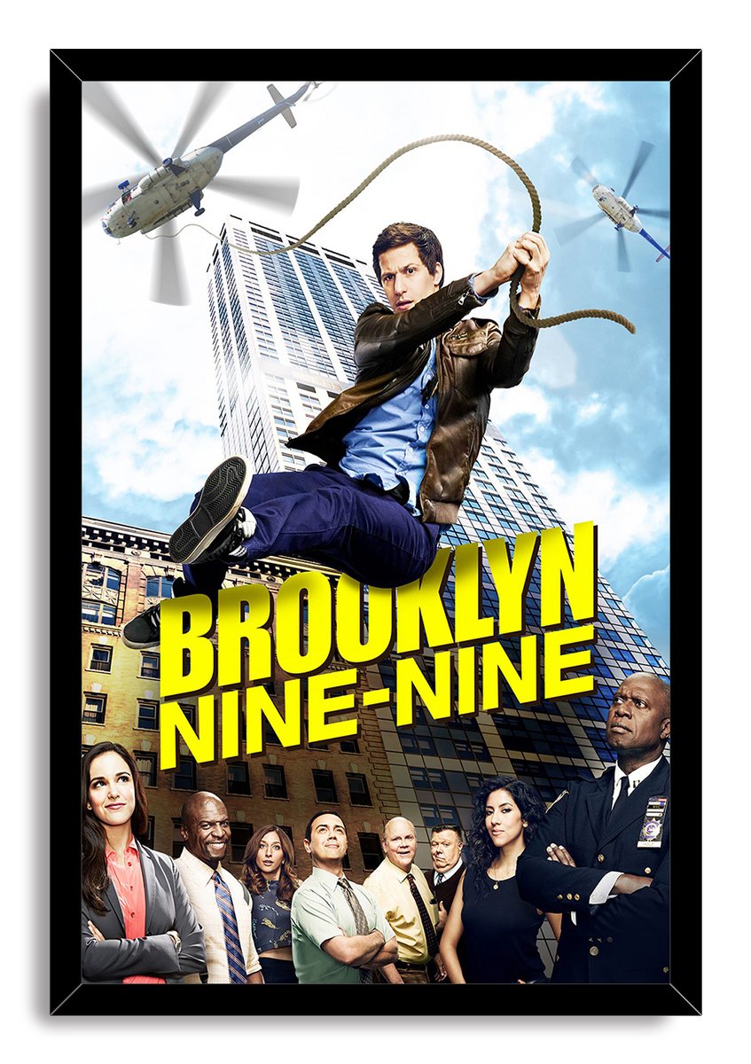 Brooklyn Nine-Nine framed wall art print with Jake Peralta swinging above the ensemble cast, skyscrapers, helicopters, and bold yellow logo.
