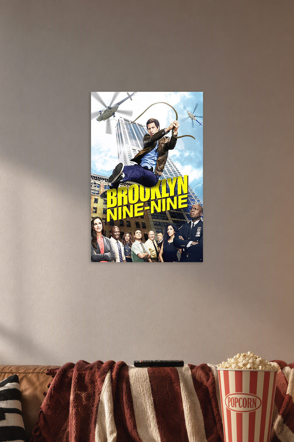 Brooklyn Nine-Nine TV Show in a cozy movie room above a brown sofa with popcorn.