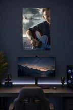 Bruce Springsteen in a gaming desk setup above a monitor.