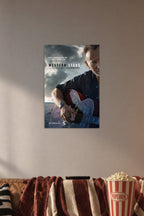 Bruce Springsteen in a cozy movie room above a brown sofa with popcorn.