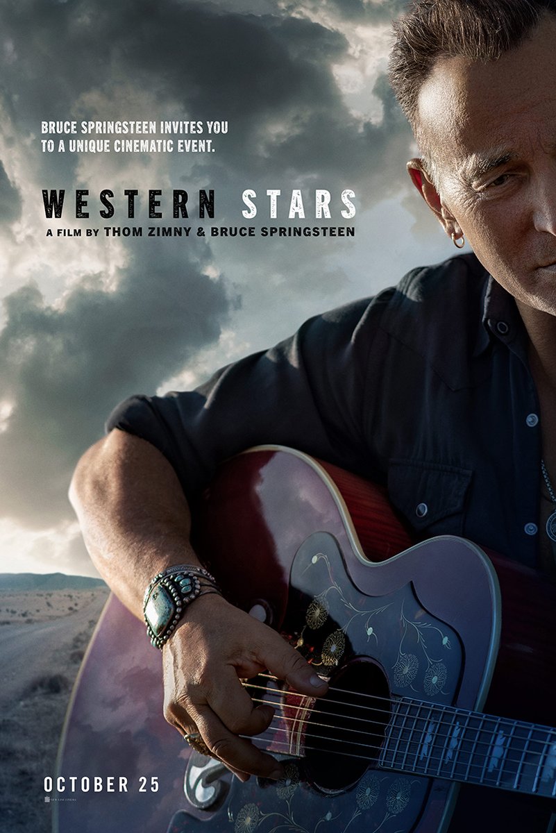 Bruce Springsteen Western Stars poster features a close-up of the musician holding a floral acoustic guitar beneath stormy desert skies.