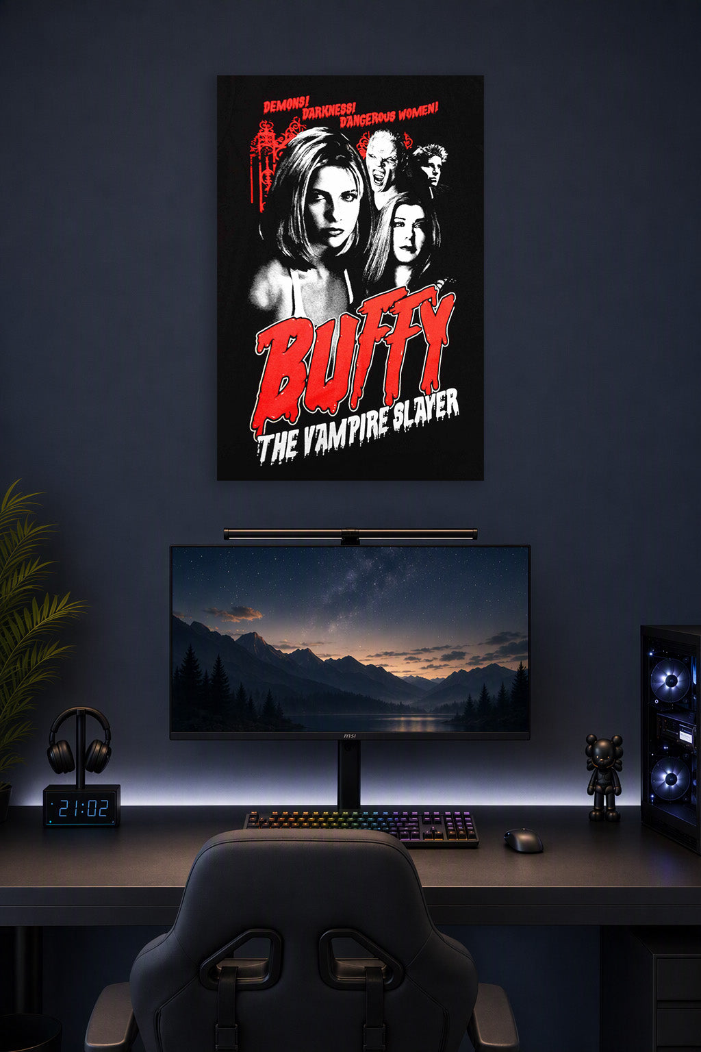 Buffy the Vampire Slayer in a gaming desk setup above a monitor.