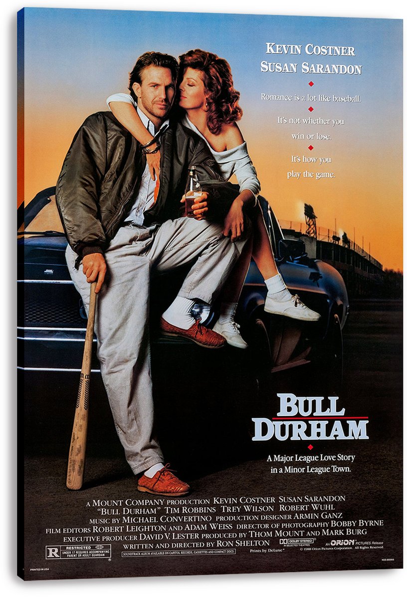 Bull Durham wall art canvas print displays Kevin Costner and Susan Sarandon beside a car with a bat and orange-blue sky.