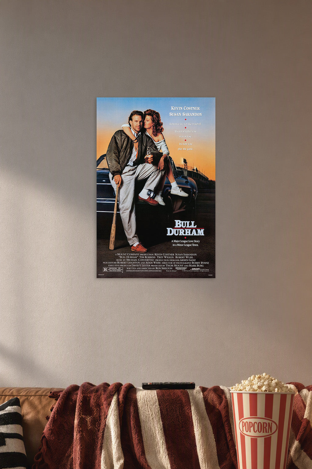 Bull Durham Movie Poster in a cozy movie room above a brown sofa with popcorn.