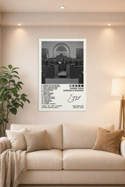 Business Is Business Poster in a bright living room above a beige sofa.