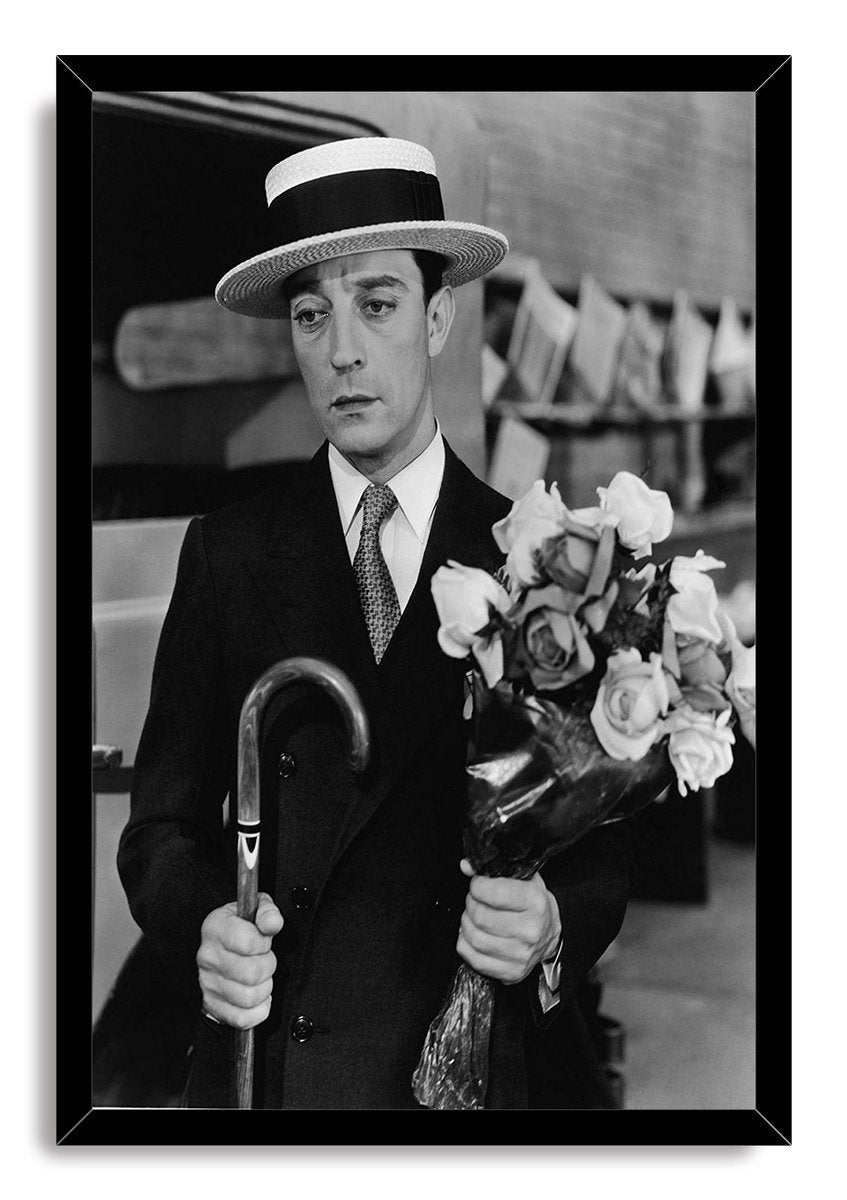 Buster Keaton framed wall art print displays a monochrome portrait of the actor in a boater hat, holding roses and a cane.