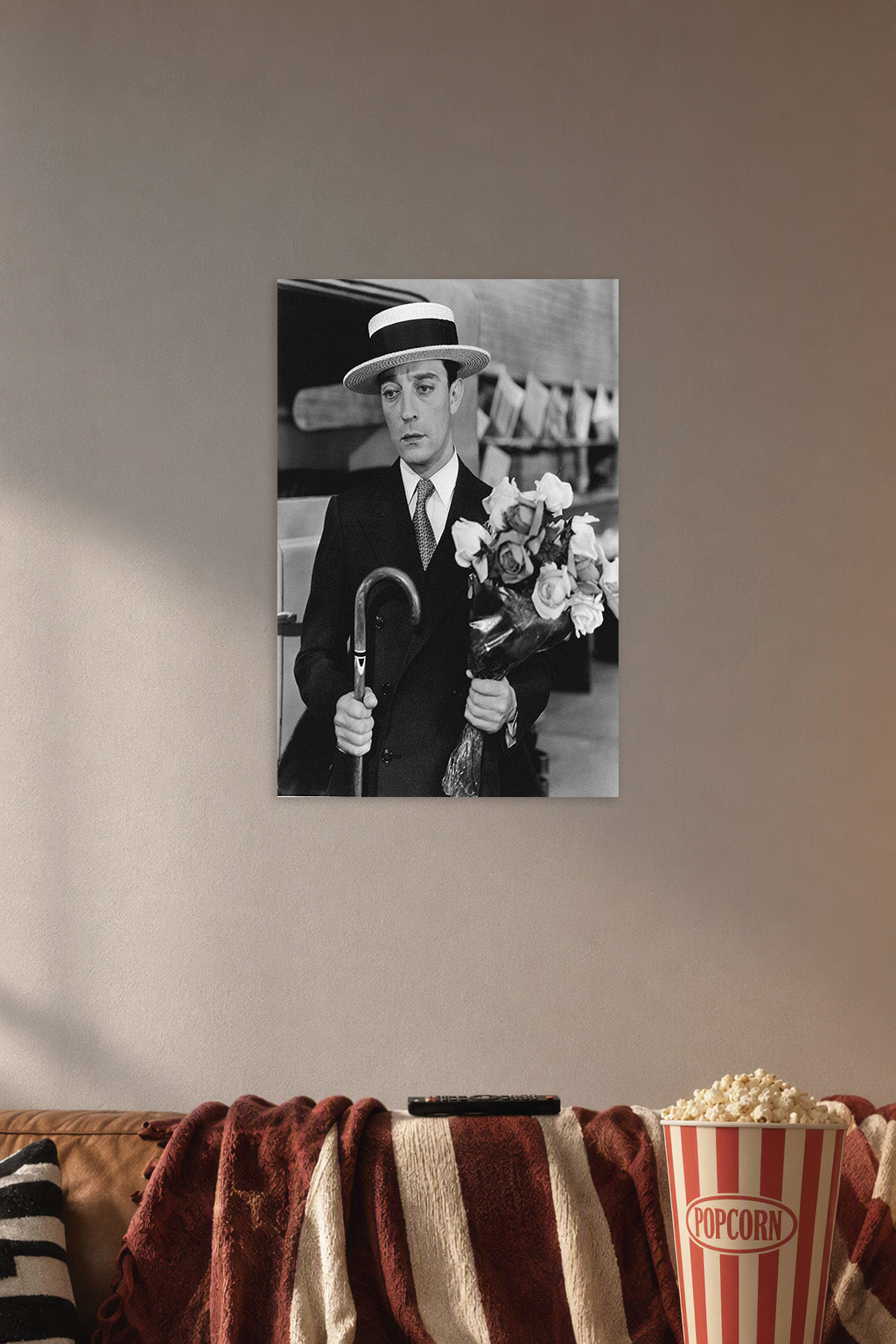 Buster Keaton in a cozy movie room above a brown sofa with popcorn.