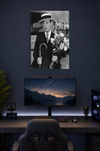 Buster Keaton in a gaming desk setup above a monitor.