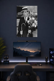 Buster Keaton in a gaming desk setup above a monitor.