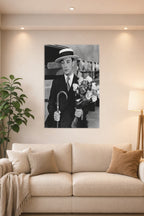 Buster Keaton in a bright living room above a beige sofa.