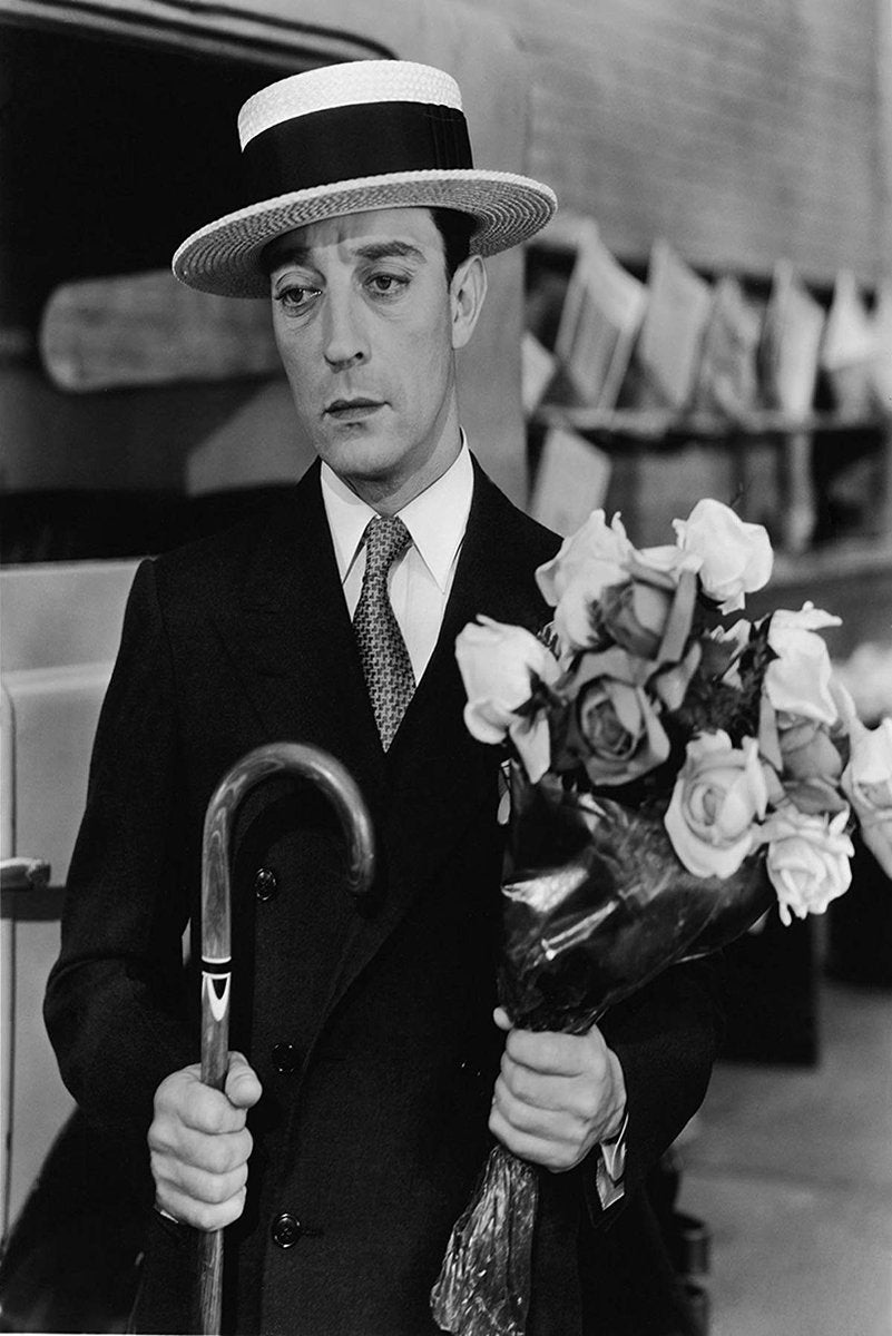 Buster Keaton poster features a black-and-white portrait of the actor in a boater hat holding a cane and bouquet of roses.