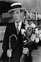 Buster Keaton poster features a black-and-white portrait of the actor in a boater hat holding a cane and bouquet of roses.