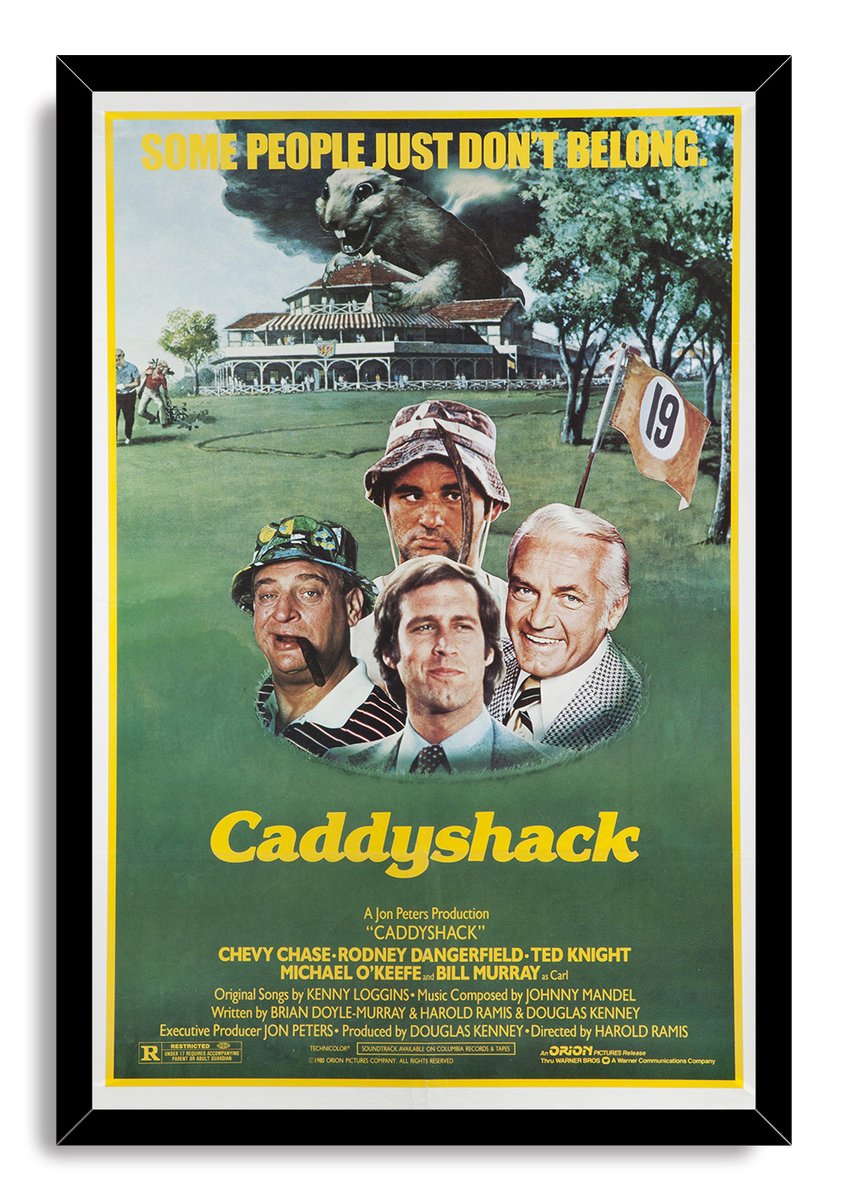 Caddyshack framed wall art print in a black frame, featuring a giant gopher, golf clubhouse, hole 19 flag, and four men.