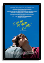 Call Me By Your Name framed wall art print with black border, yellow title text, review quotes, and two men looking upward.