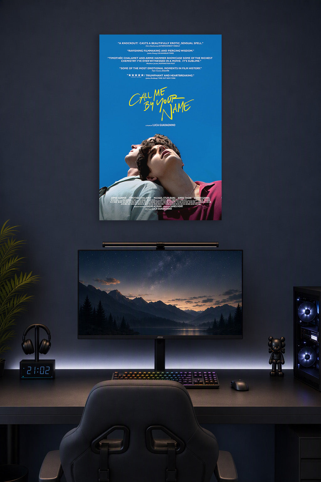 Call Me By Your Name Movie Poster in a gaming desk setup above a monitor.