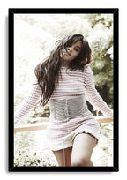 Camila Cabello framed wall art print with a black border, portraying her in a striped dress in a leafy outdoor setting.