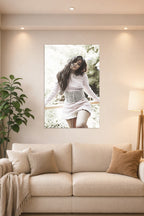 Camila Cabello in a bright living room above a beige sofa.