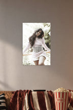 Camila Cabello in a cozy movie room above a brown sofa with popcorn.