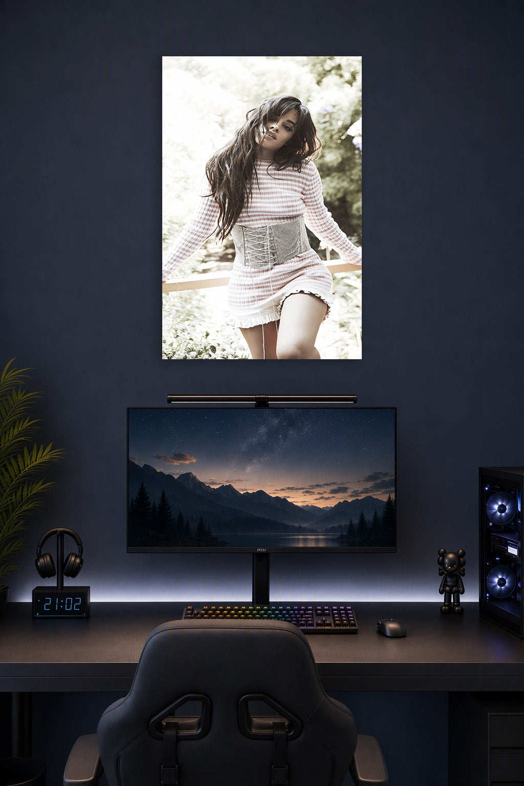 Camila Cabello in a gaming desk setup above a monitor.