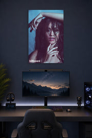 Camila Cabello in a gaming desk setup above a monitor.