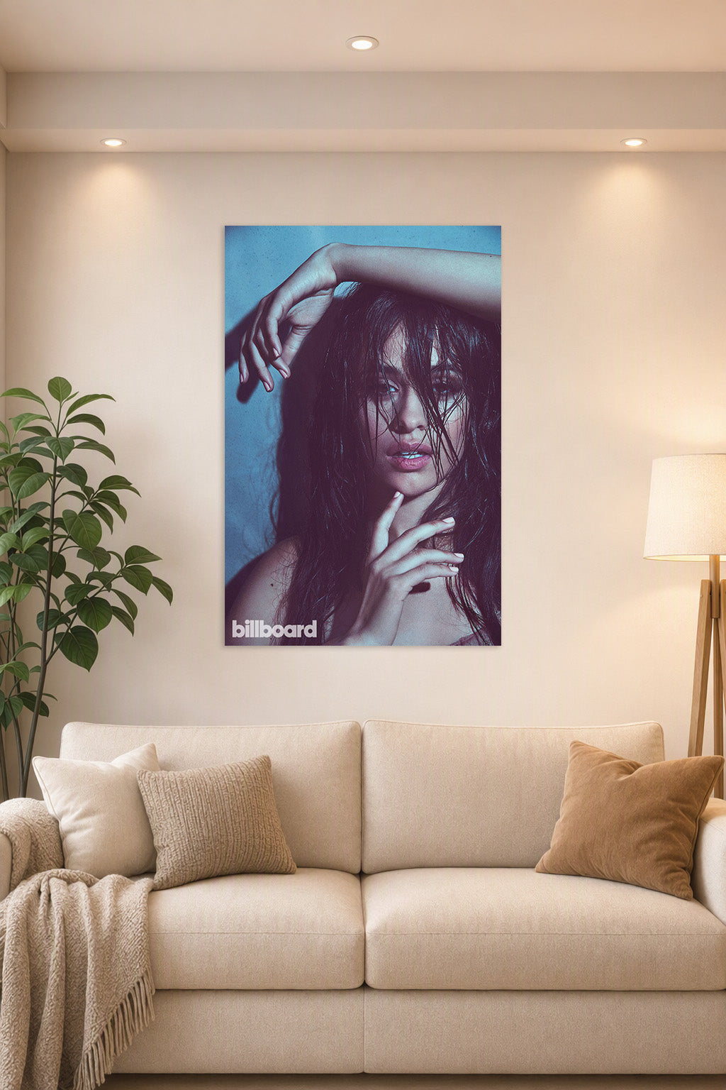 Camila Cabello in a bright living room above a beige sofa.