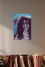 Camila Cabello in a cozy movie room above a brown sofa with popcorn.