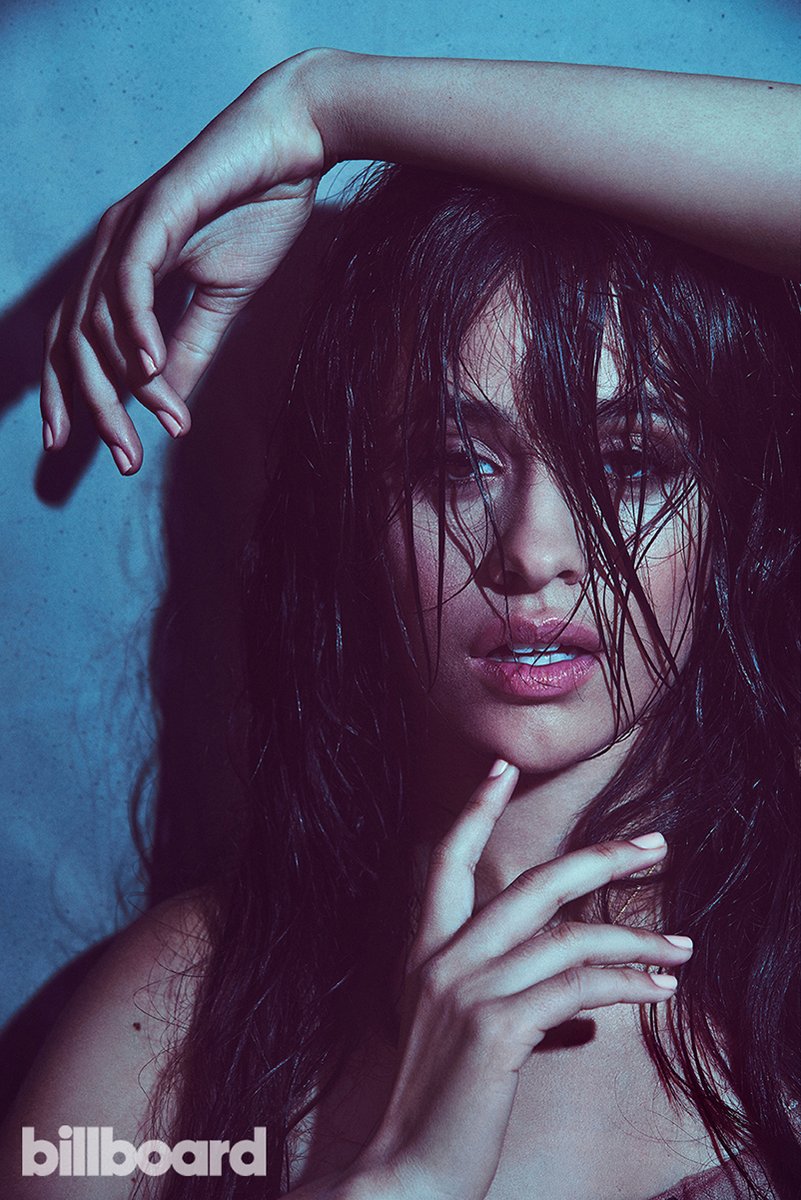 Camila Cabello poster features a moody close-up with wet dark hair, raised arms, and a blue-purple backdrop.