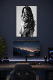 Camila Cabello in a gaming desk setup above a monitor.