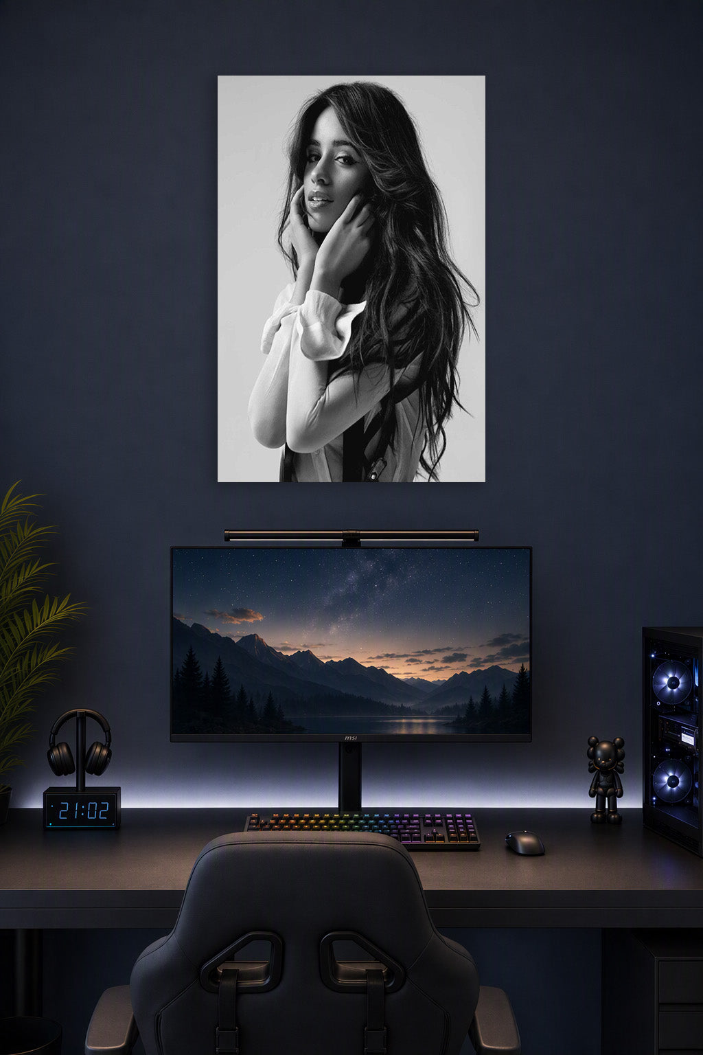 Camila Cabello in a gaming desk setup above a monitor.