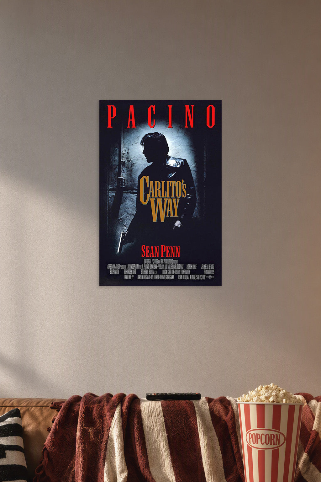 Carlito's Way Al Pacino in a cozy movie room above a brown sofa with popcorn.