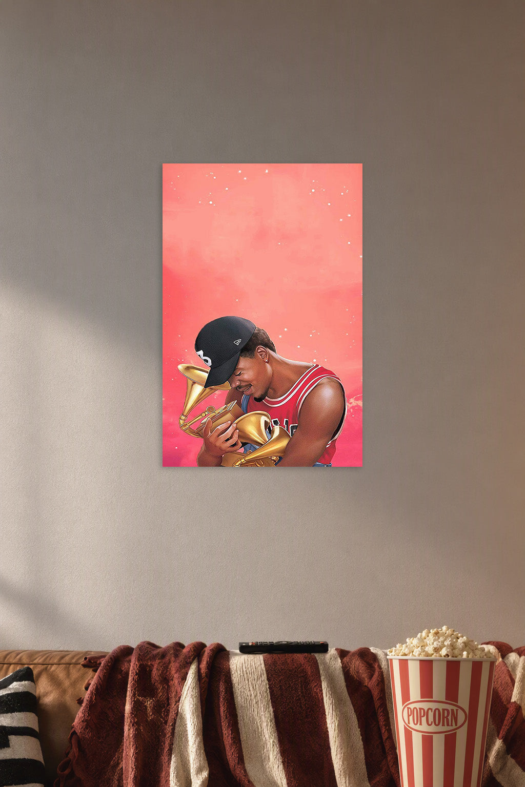 Chance the Rapper in a cozy movie room above a brown sofa with popcorn.