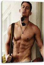 Channing Tatum canvas wall art print displays a shirtless man with sunglasses and a shoulder bag against a pale interior doorway.