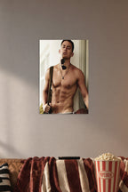 Channing Tatum in a cozy movie room above a brown sofa with popcorn.