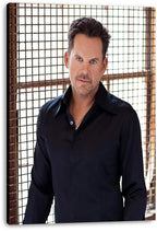 Male celebrity canvas wall art print featuring a blue-eyed man in a dark shirt against a bright gridded window.