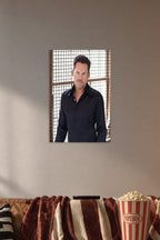 Charismatic Male Celebrity in a cozy movie room above a brown sofa with popcorn.