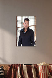 Charismatic Male Celebrity in a cozy movie room above a brown sofa with popcorn.