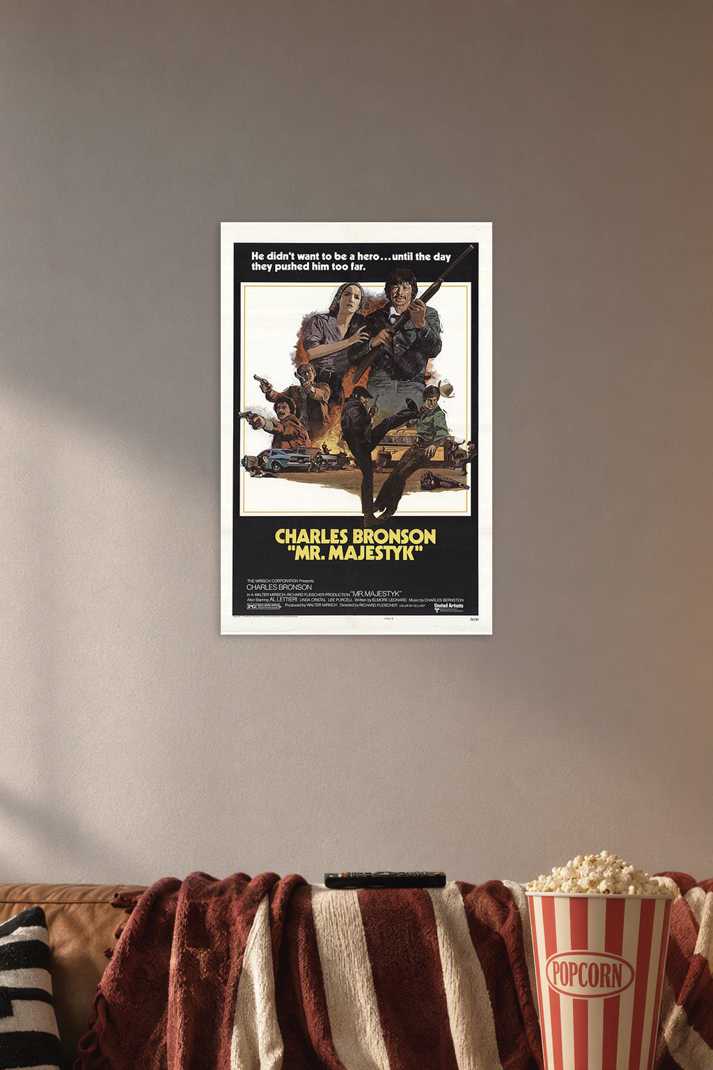 Charles Bronson Mr. Majestyk Movie Poster in a cozy movie room above a brown sofa with popcorn.