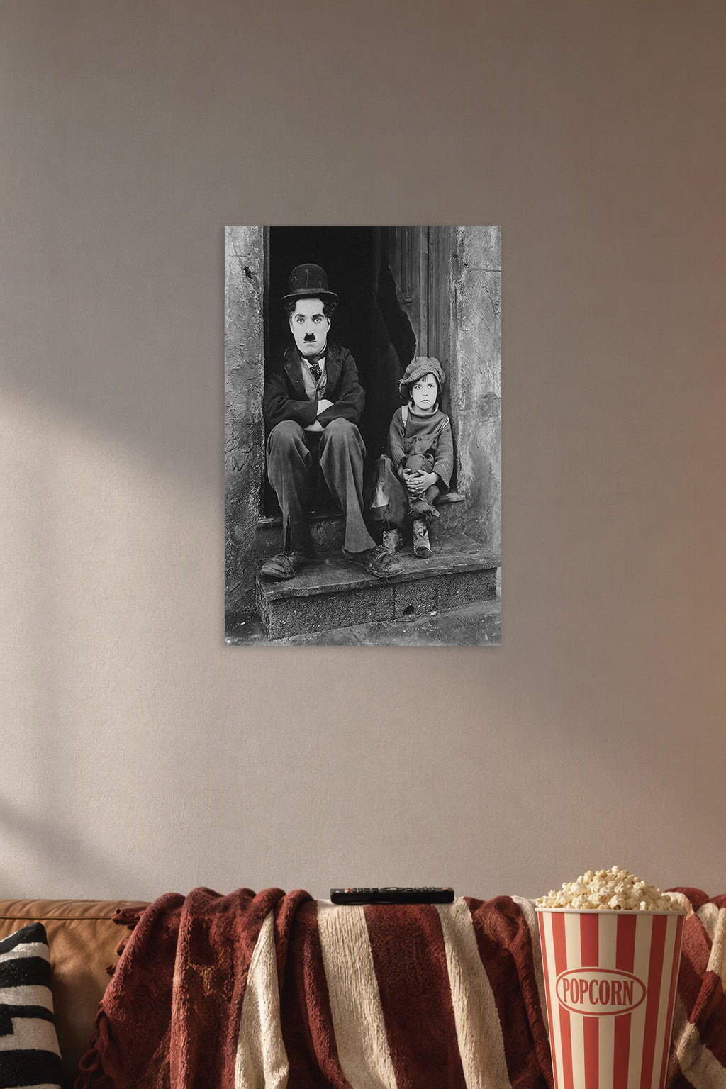 Charlie Chaplin The Kid in a cozy movie room above a brown sofa with popcorn.