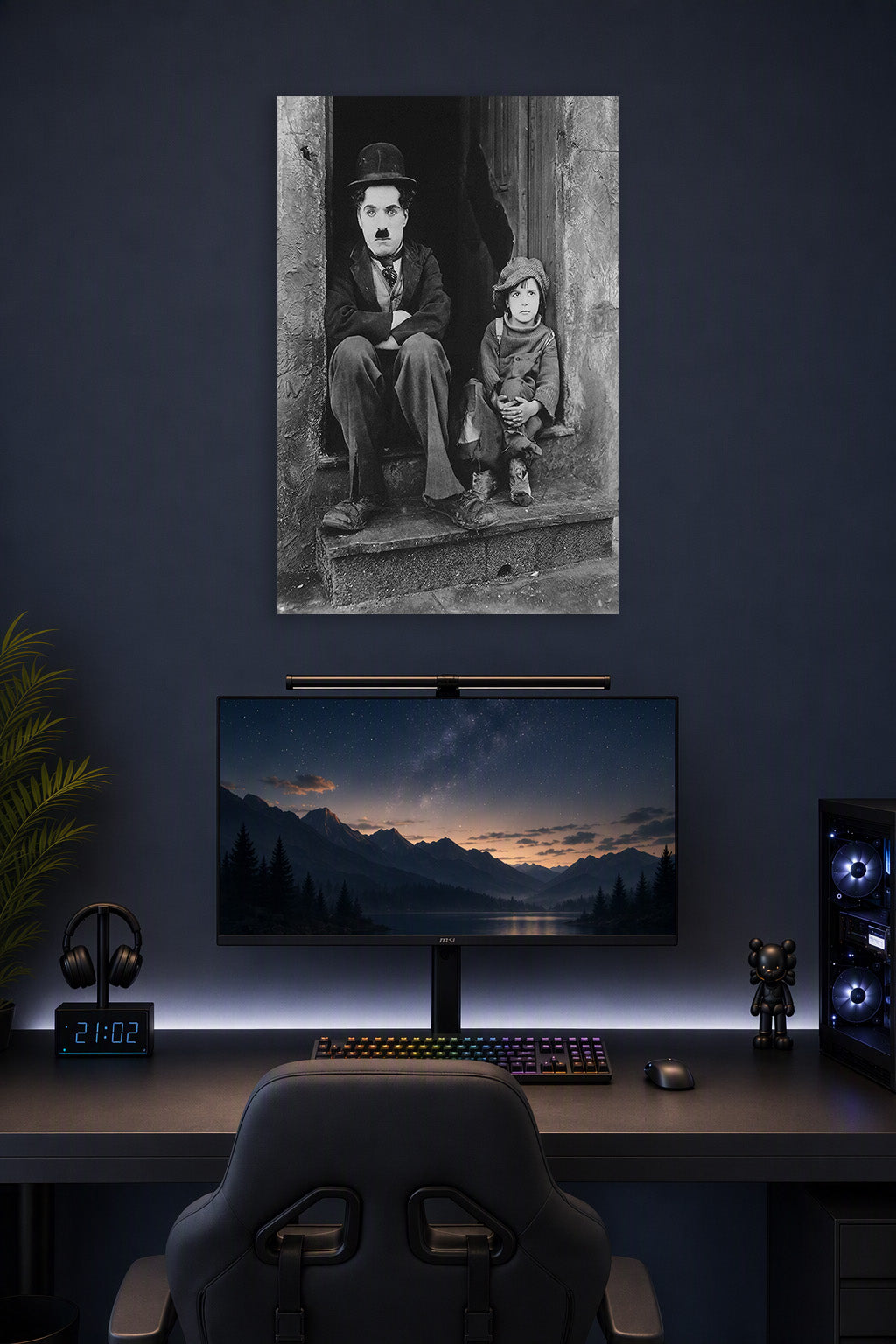 Charlie Chaplin The Kid in a gaming desk setup above a monitor.