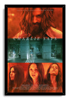 Charlie Says framed wall art print in a black frame, with red portraits, teal prison bars, and the film title.