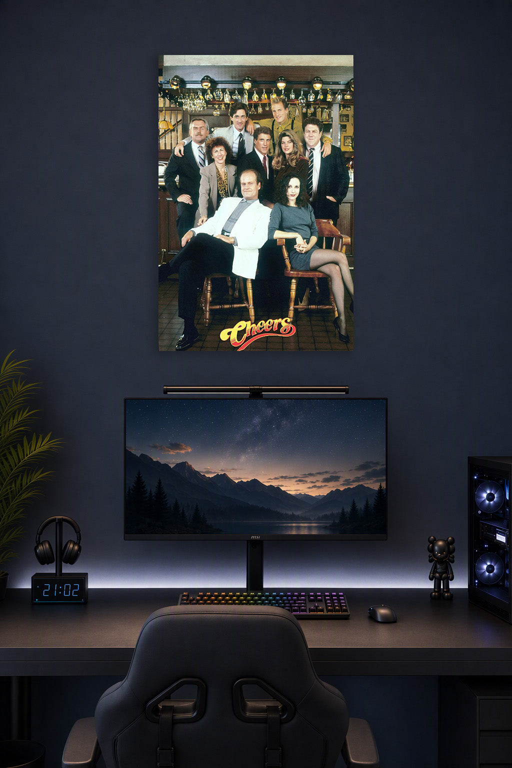 Cheers TV Show Cast in a gaming desk setup above a monitor.